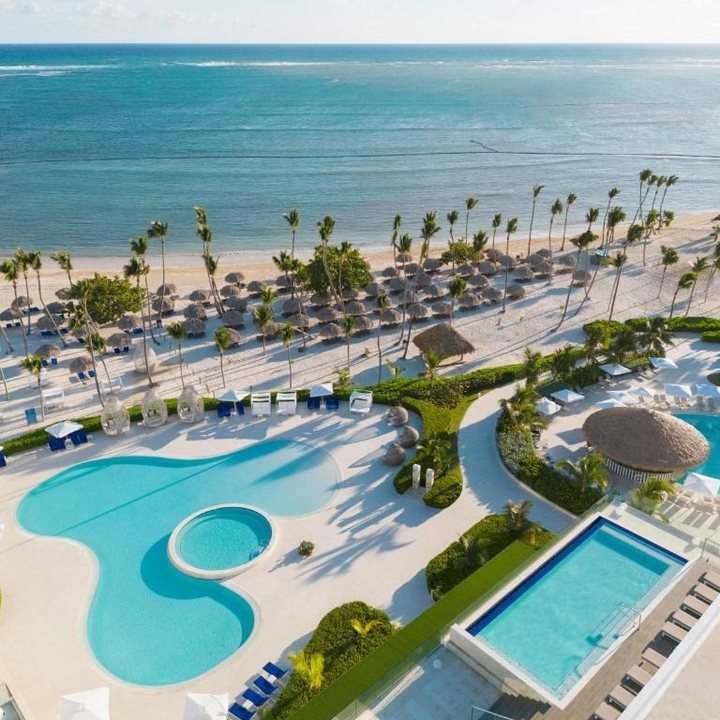 Aerial view of a beachfront resort with pools
